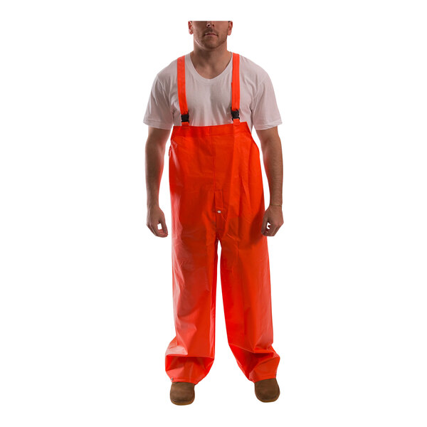 A person wearing an orange Tingley rainsuit.