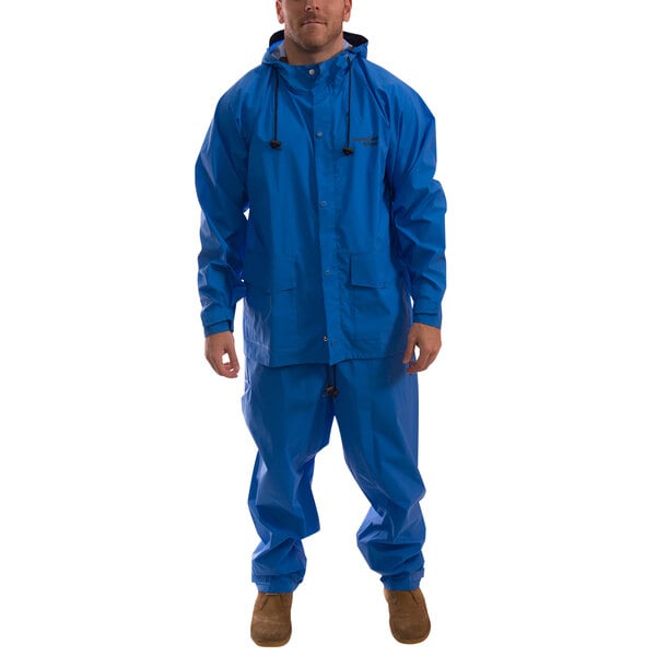 A man wearing a Tingley blue 2-piece rainsuit.