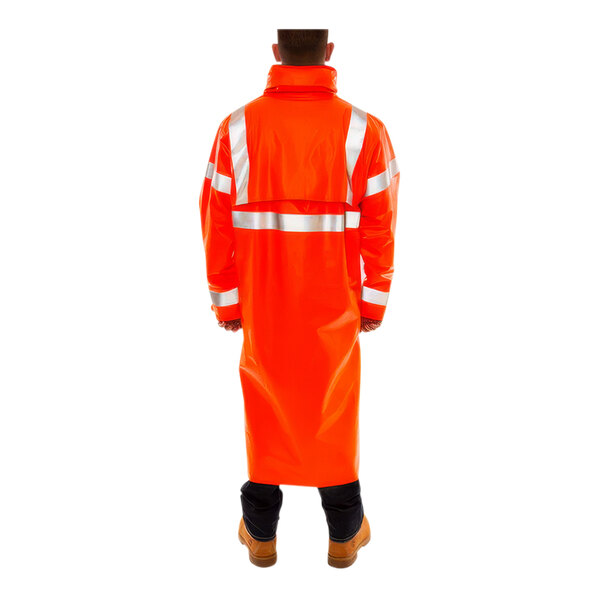 A person wearing a Tingley orange raincoat with reflective stripes.