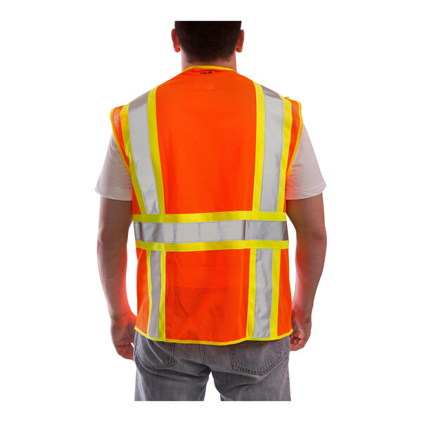 A man wearing a Tingley orange safety vest with reflective stripes.