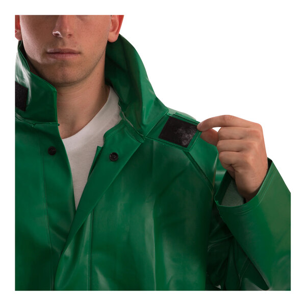 A man wearing a green Tingley SafetyFlex rain jacket with a button.