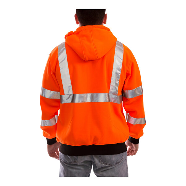 A person wearing a Tingley hi-vis orange zip-up sweatshirt with reflective stripes.