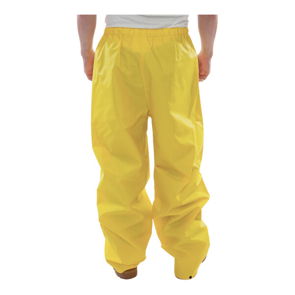 A person wearing yellow Tingley DuraScrim pants.