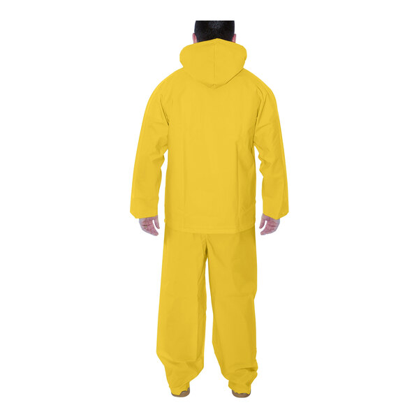 A man wearing a yellow Tingley Industrial Work rainsuit.