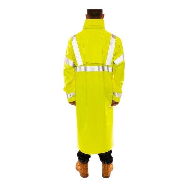 A man wearing a Tingley yellow industrial work coat with reflective tape.