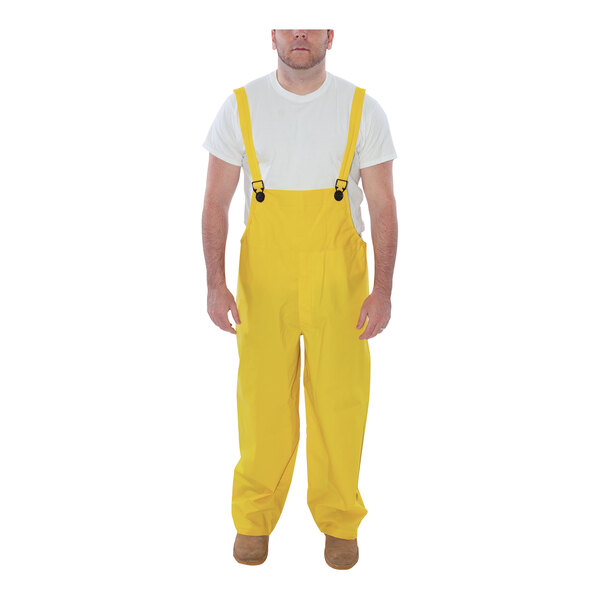A man wearing yellow Tingley Industrial overalls.