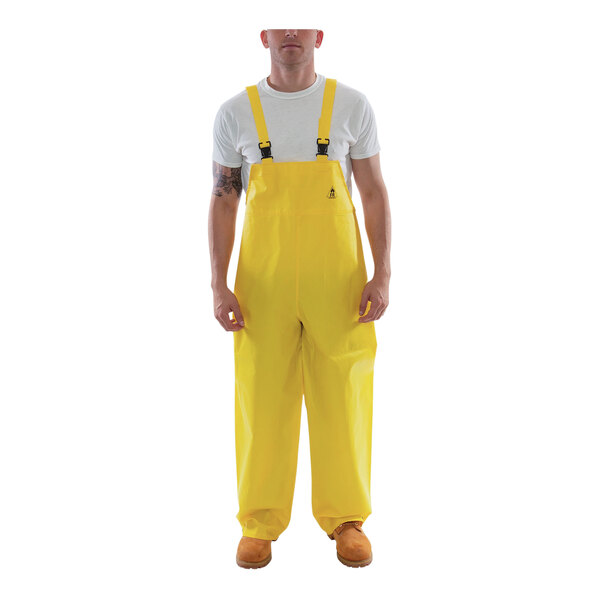 A man wearing yellow Tingley overalls.