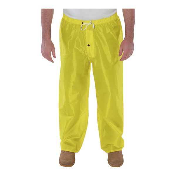 A man wearing yellow Tingley Eagle rain pants.