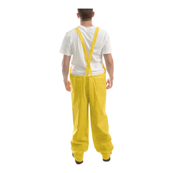 A man wearing a Tingley yellow rainsuit.