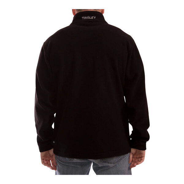 A man wearing a Tingley lime and black jacket with black panels and a black shirt.