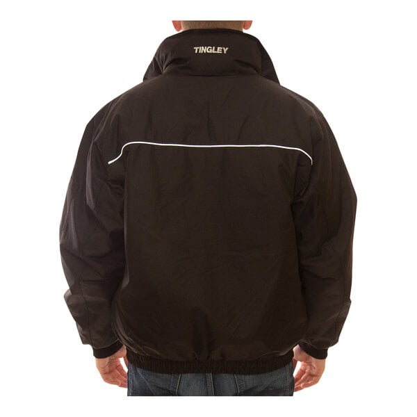 A person wearing a black Tingley Bomber insulated jacket.