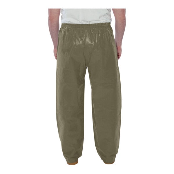 A person wearing Tingley olive green pants and a white shirt.