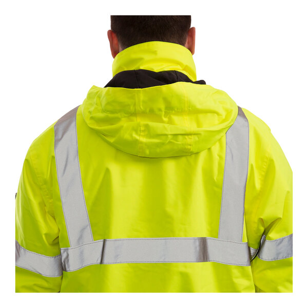 A person wearing a Tingley hi-vis yellow jacket with black panels and reflective stripes.