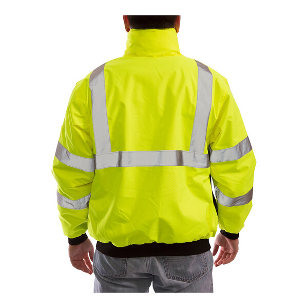 A man wearing a Tingley yellow and black industrial work jacket.
