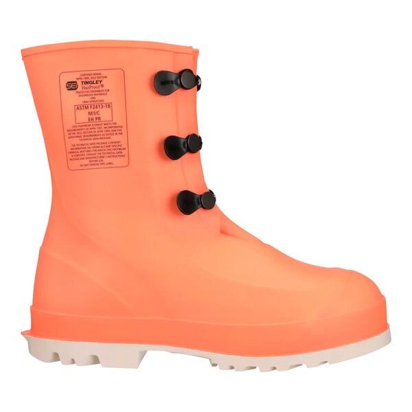 A close up of a Tingley orange rubber safety boot with black laces.