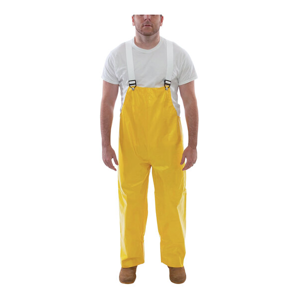 A man wearing yellow Tingley American overalls.