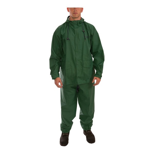 A man wearing a green Tingley Storm-Champ rainsuit.