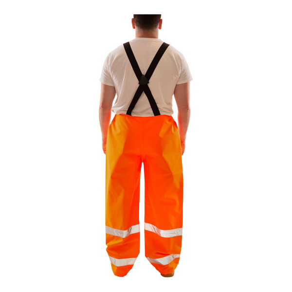 Tingley Icon orange and black overalls with black straps.