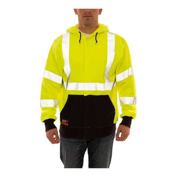 A man wearing a lime hi-vis flame-resistant zip-up sweatshirt.