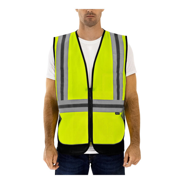 A man wearing a Tingley hi-vis lime safety vest with X-back reflective tape.