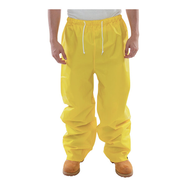 A person wearing yellow Tingley DuraScrim work pants.