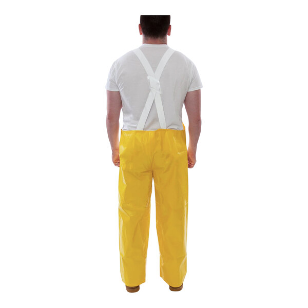 A man wearing Tingley yellow overalls.