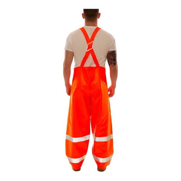 A person wearing Tingley orange overalls with reflective stripes.