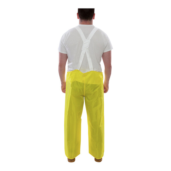 A man wearing Tingley yellow overalls.