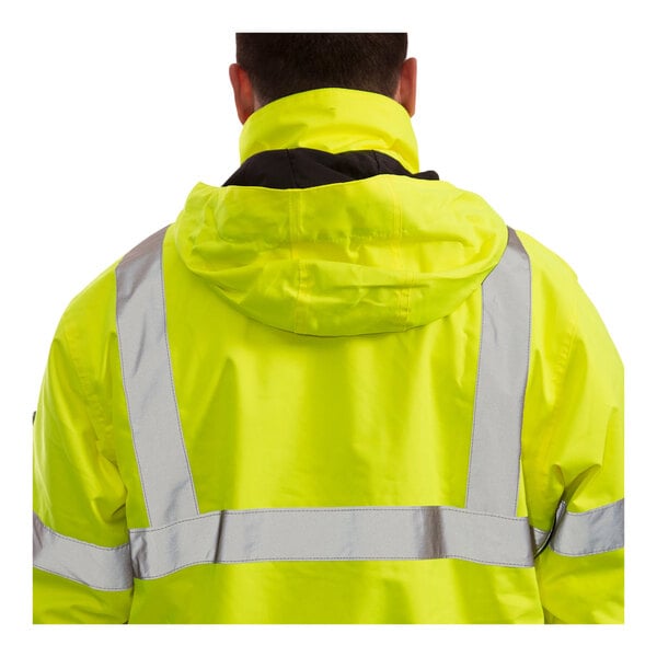 A person wearing a Tingley yellow and black safety jacket with reflective stripes.