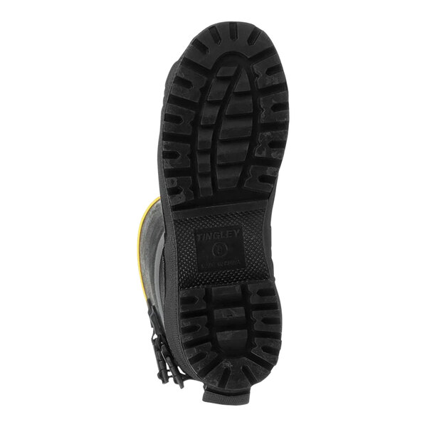 A black Tingley steel toe boot with yellow soles.