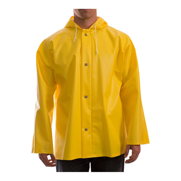 A person wearing a yellow Tingley Webdri rain jacket with a hood.
