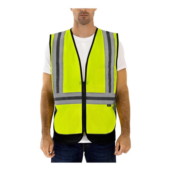 A man wearing a Tingley lime yellow mesh safety vest with reflective tape on the back.