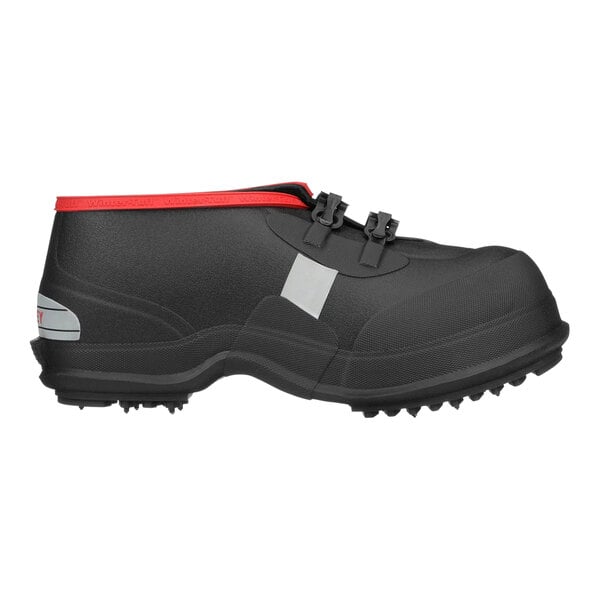 A black Tingley rubber overshoe with red trim.