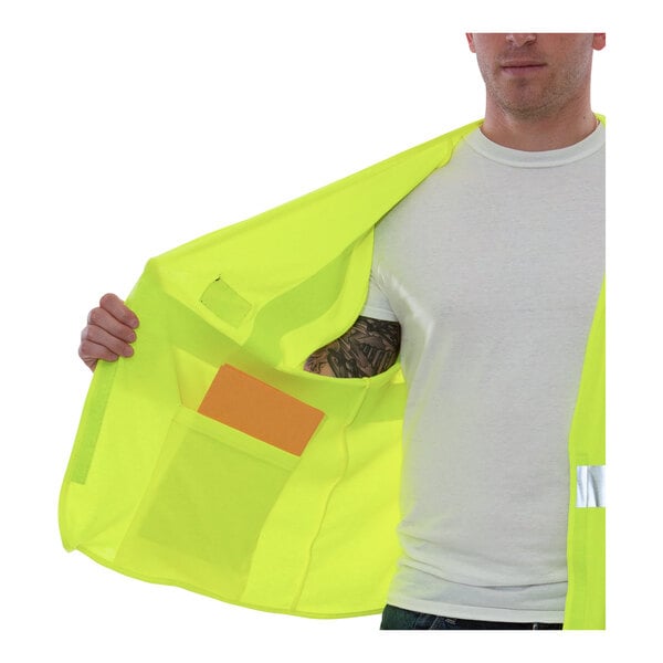 A man wearing a Tingley lime yellow safety vest with an orange pocket.