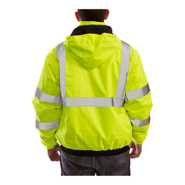 The back of a person wearing a yellow Tingley Bomber II safety jacket with black panels.