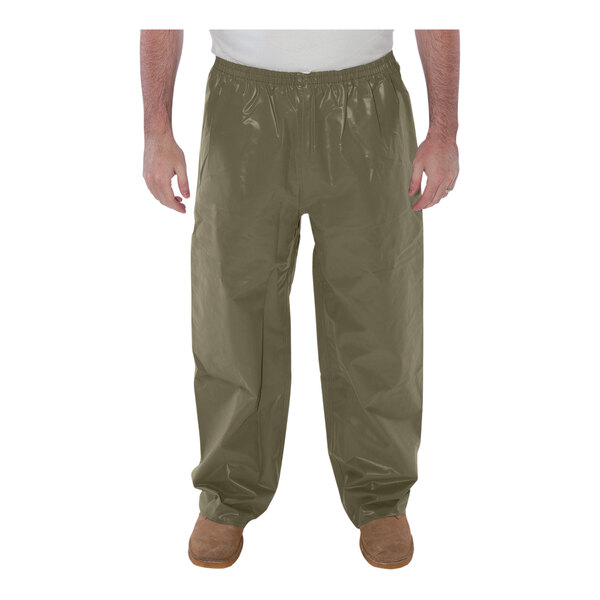 A man wearing Tingley Magnaprene olive drab pants.