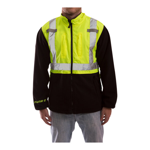 A man wearing a Tingley yellow and black heavy weight fleece jacket with reflective stripes.