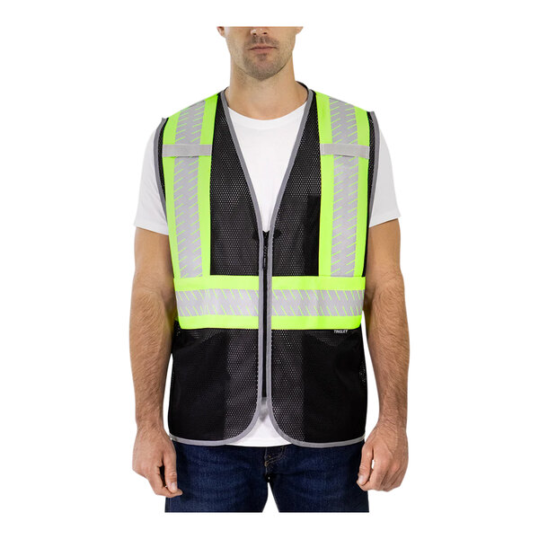 A man wearing a Tingley high-vis black mesh safety vest with reflective stripes.