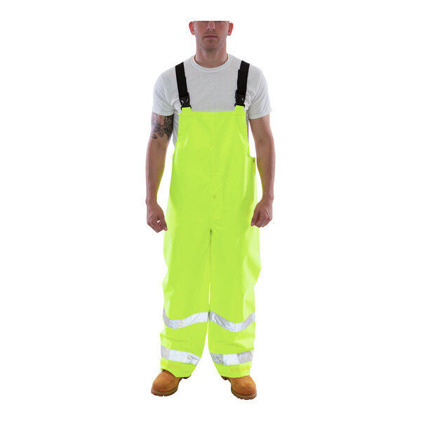 A man wearing Tingley lime yellow overalls.