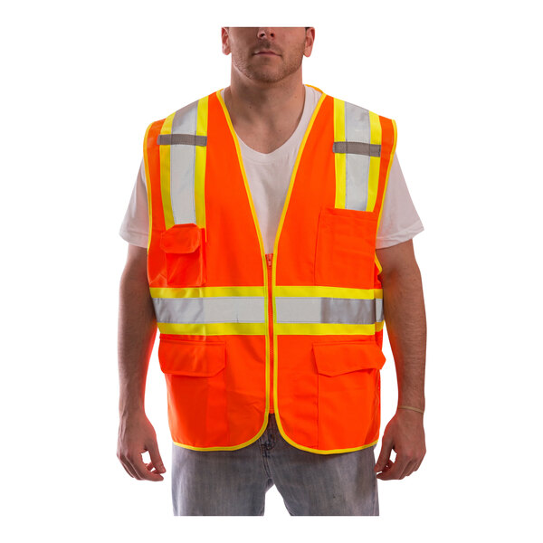 A man wearing a Tingley hi-vis orange safety vest with reflective stripes.