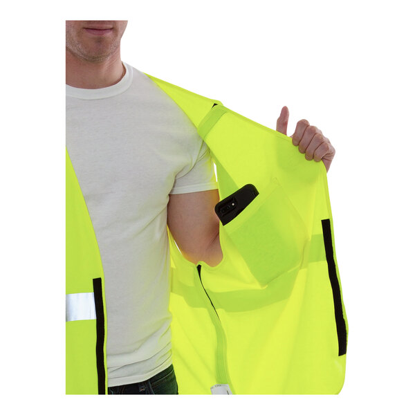 A man holding a Tingley Hi-Vis yellow safety vest with a pocket.