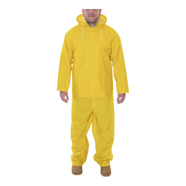 A man wearing a yellow Tingley Industrial Work rainsuit.