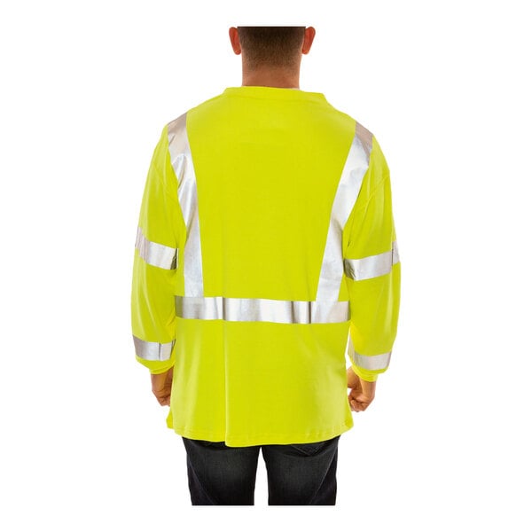A man wearing a Tingley lime yellow flame-resistant long sleeve safety shirt.