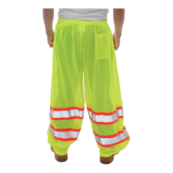 Tingley Job Sight Class E Hi-Vis Lime Mesh Pants with reflective stripes on a person.