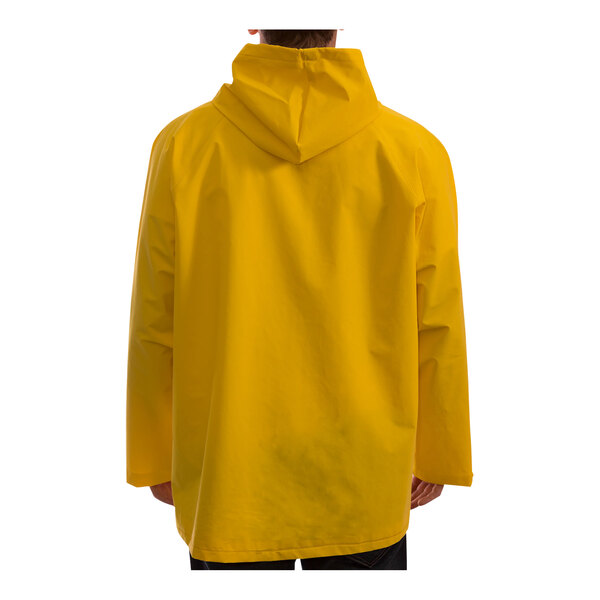 A man wearing a yellow Tingley industrial work jacket with a hood.