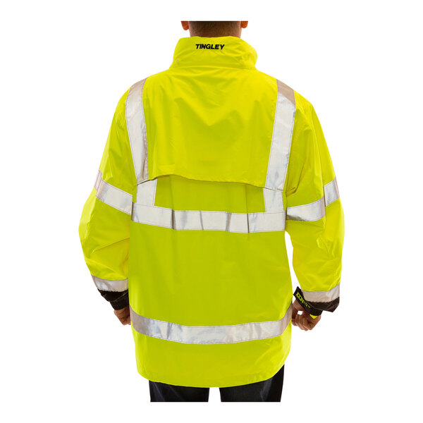 A person wearing a Tingley Icon LTE Hi-Vis yellow and black jacket.
