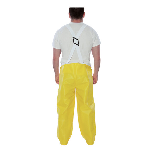 A man wearing Tingley yellow overalls.