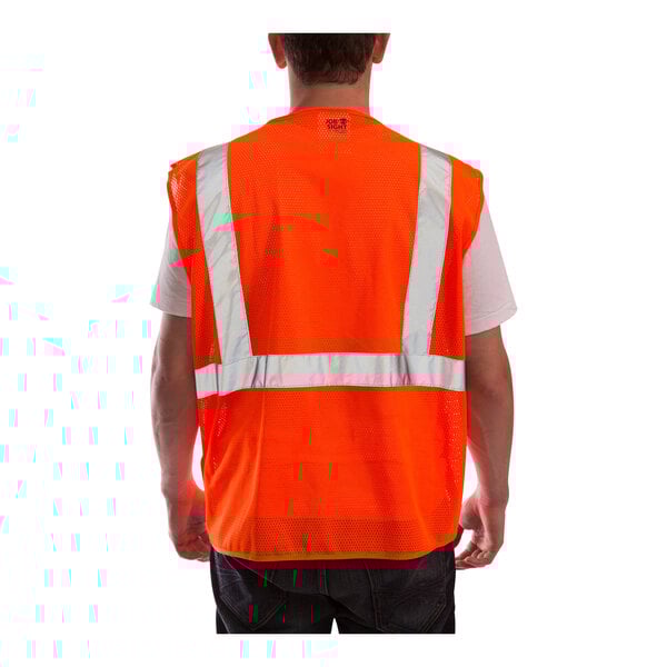 A man wearing a Tingley hi-vis orange safety vest with reflective stripes.