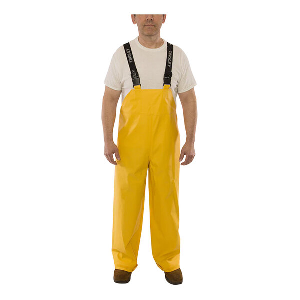 A man wearing yellow Tingley Weather-Tuff overalls.