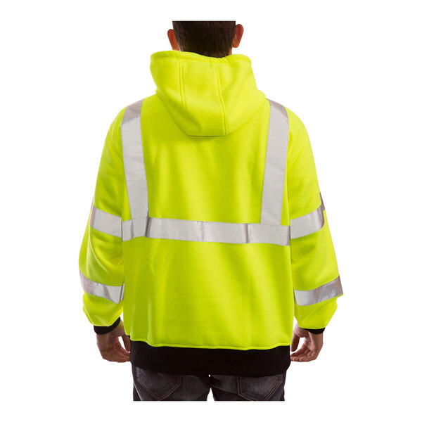 A person wearing a Tingley Hi-Vis lime pullover sweatshirt.